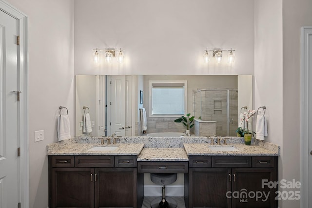 bathroom with vanity and independent shower and bath