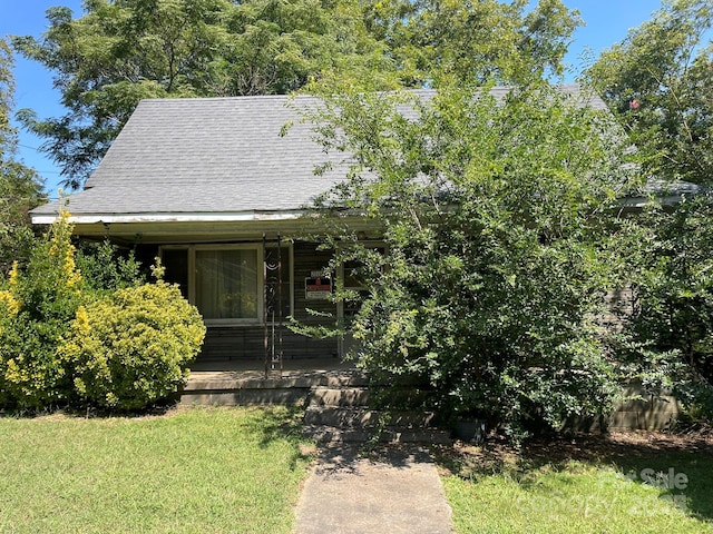 obstructed view of property featuring a front yard