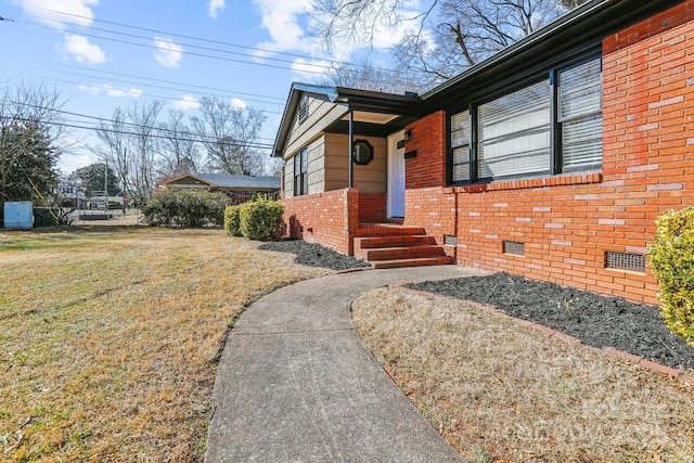 doorway to property with a yard