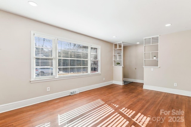 unfurnished room with wood-type flooring