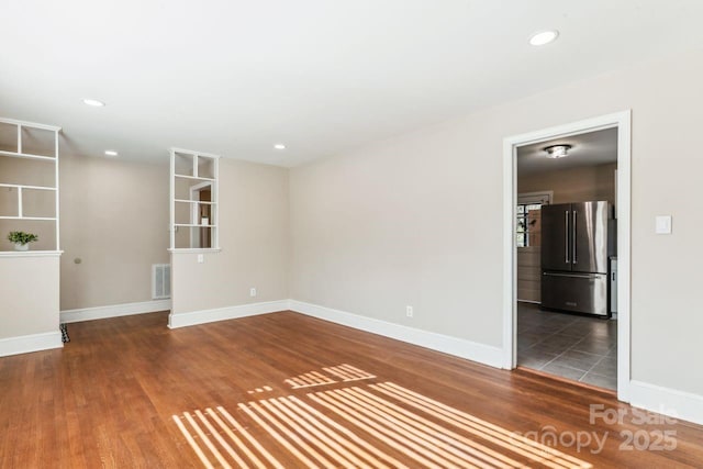 spare room featuring dark hardwood / wood-style flooring