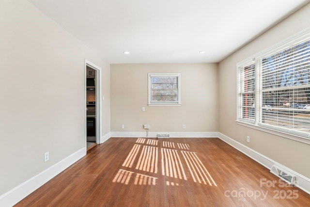 spare room with hardwood / wood-style floors