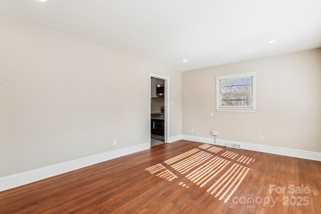 unfurnished room with hardwood / wood-style floors