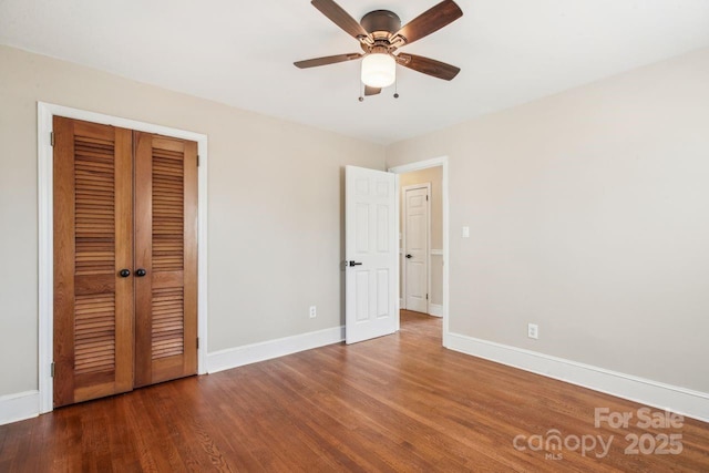 unfurnished bedroom featuring hardwood / wood-style flooring, ceiling fan, and a closet