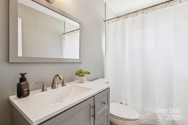 bathroom featuring vanity and toilet