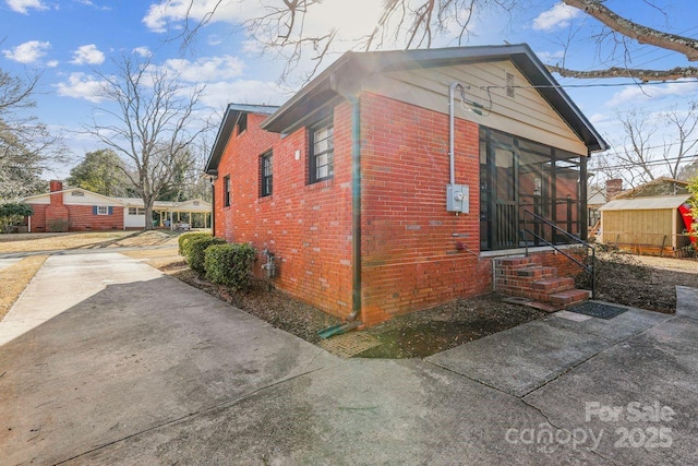 view of property exterior featuring a sunroom