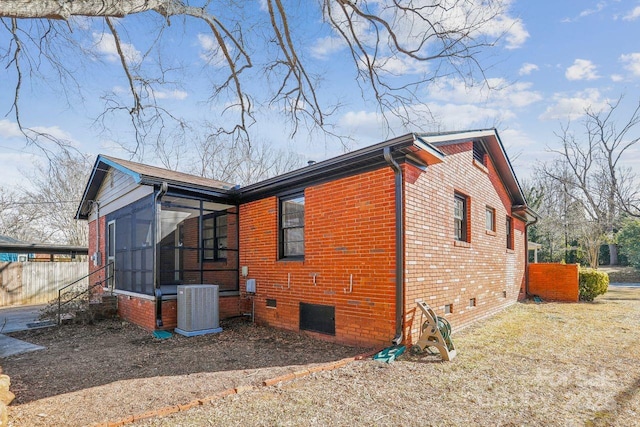 view of side of property with cooling unit and a sunroom