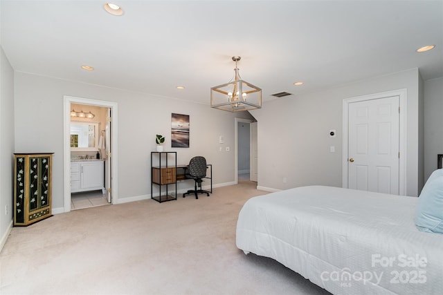 carpeted bedroom featuring an inviting chandelier and connected bathroom