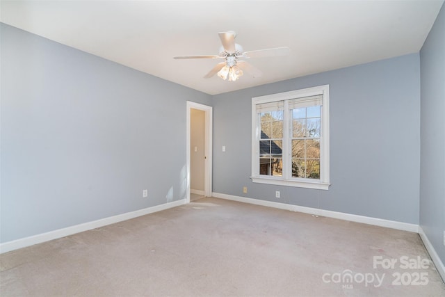 empty room featuring light colored carpet and ceiling fan