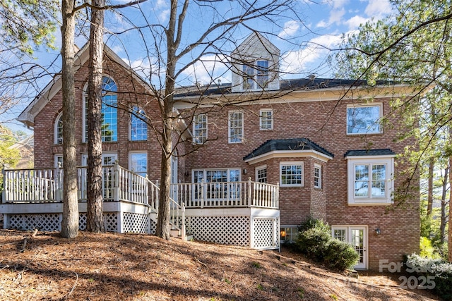 back of house featuring a wooden deck