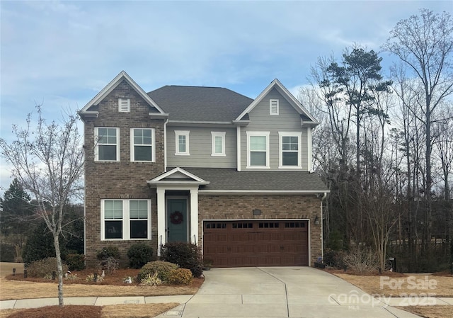 view of front of house with driveway, a shingled roof, a garage, and brick siding