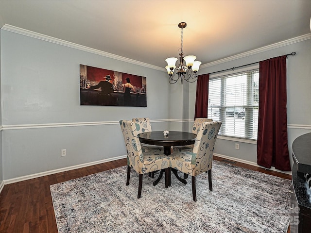 dining space featuring crown molding, dark wood-type flooring, and a chandelier