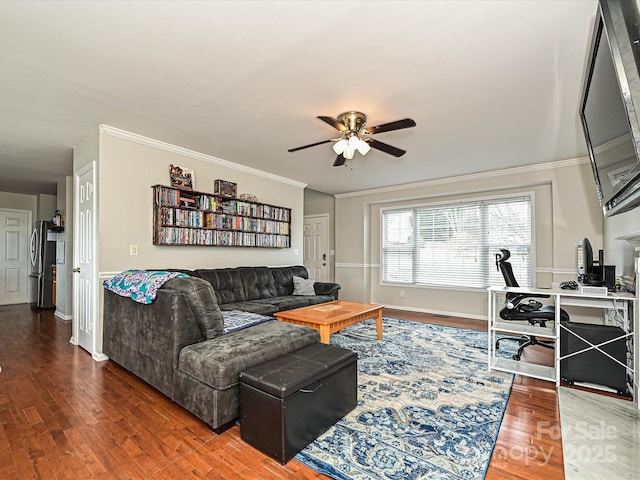 living room featuring hardwood / wood-style floors, ornamental molding, and ceiling fan