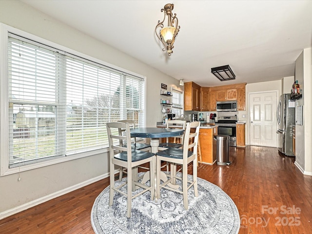 dining area with dark hardwood / wood-style floors