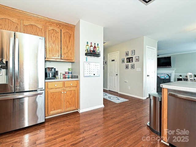 kitchen featuring stainless steel fridge and dark hardwood / wood-style floors