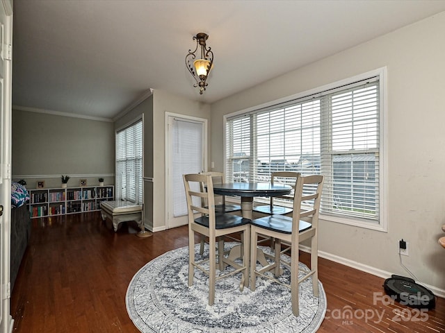 dining area with crown molding, a wealth of natural light, and dark hardwood / wood-style floors