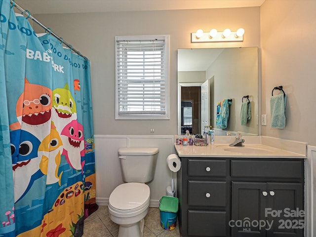 bathroom with vanity, curtained shower, tile patterned floors, and toilet