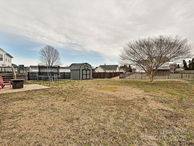 view of yard featuring a fire pit and a shed