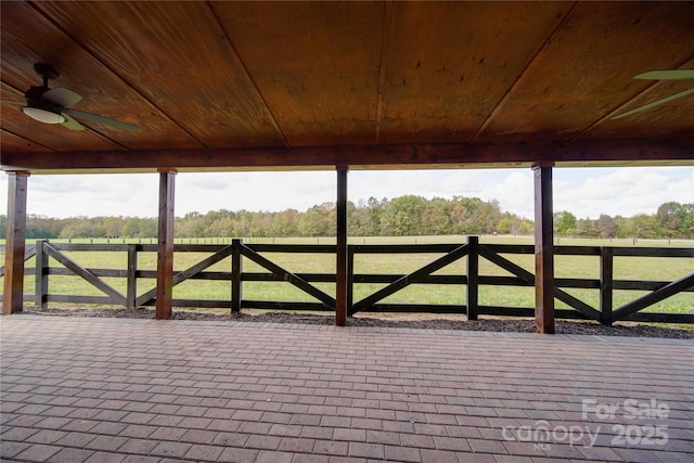 view of gate featuring a rural view, a patio, and ceiling fan