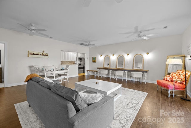 living room with dark hardwood / wood-style floors and ceiling fan