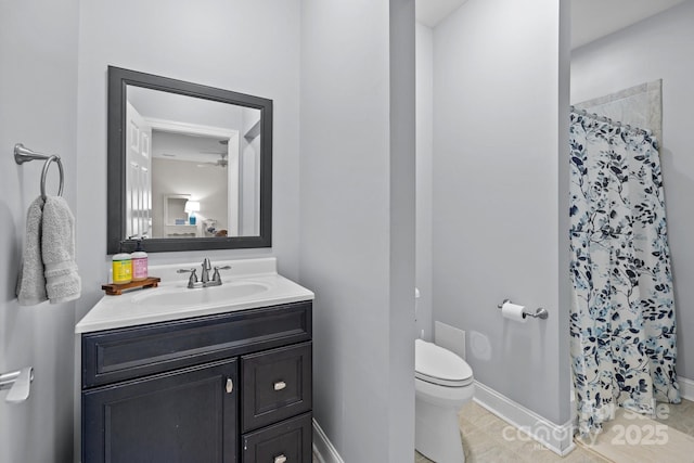 bathroom featuring vanity, toilet, and a shower with shower curtain