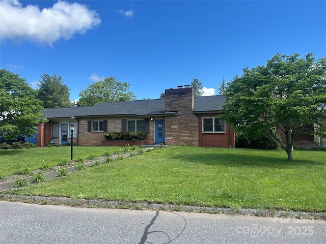 ranch-style house featuring roof with shingles, a chimney, a front lawn, and brick siding