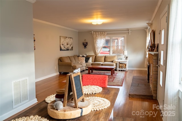 living room featuring crown molding, wood finished floors, and visible vents