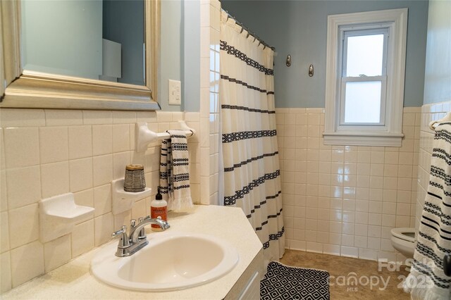 bathroom with tile patterned flooring, toilet, a wainscoted wall, tile walls, and curtained shower