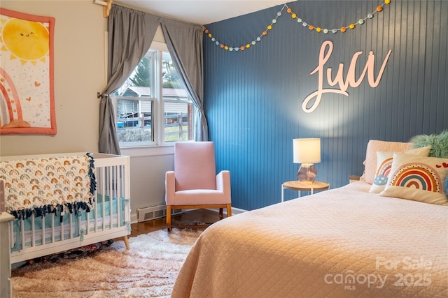 bedroom with visible vents, baseboards, and wood finished floors