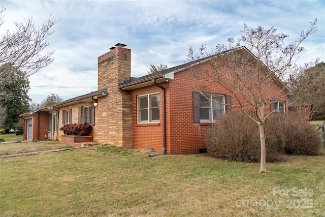 view of side of home with a yard, brick siding, a chimney, and a garage
