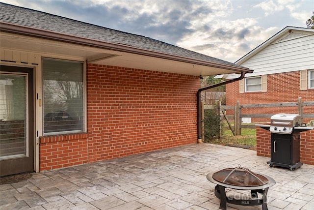view of patio / terrace featuring a fire pit, fence, and grilling area