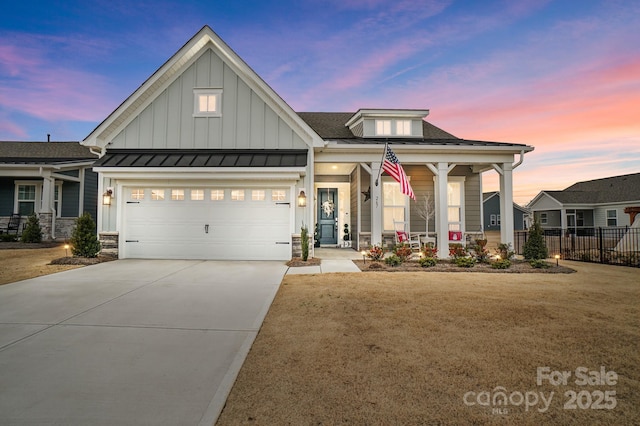 view of front of house featuring a garage, a yard, and a porch