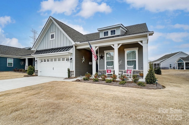 view of front of house with a garage, a front yard, and a porch