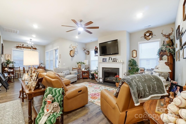 living room featuring light wood-type flooring and ceiling fan