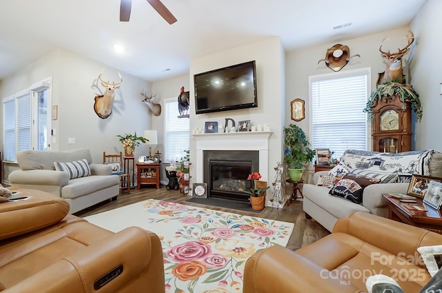 living room with ceiling fan and dark hardwood / wood-style floors