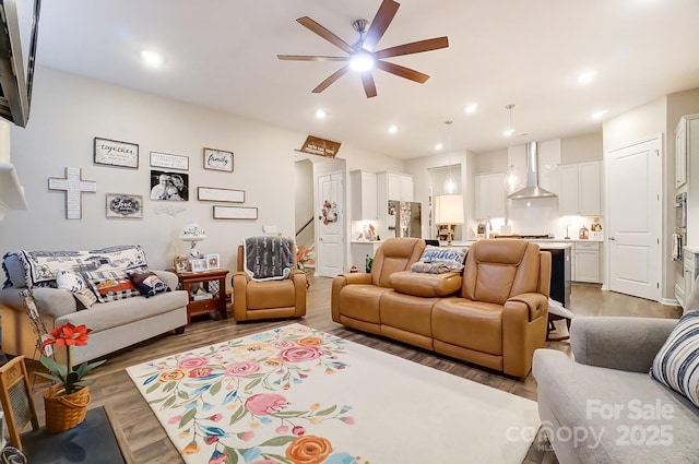 living room with ceiling fan and wood-type flooring