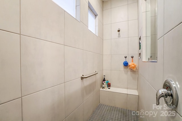 bathroom with tiled shower