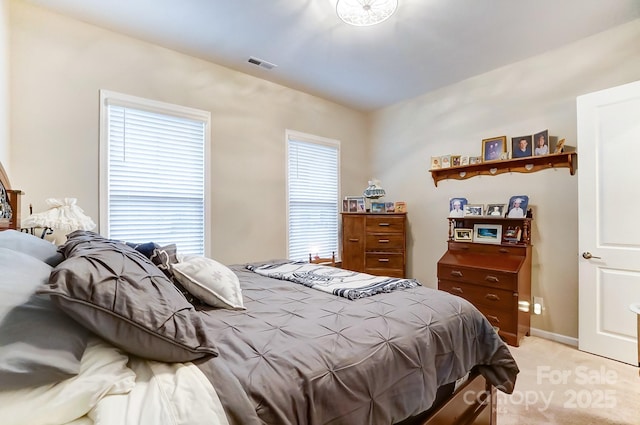 carpeted bedroom featuring multiple windows