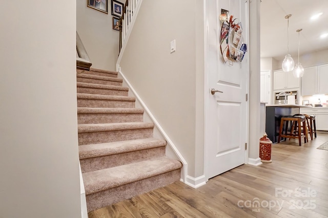 stairway with hardwood / wood-style floors