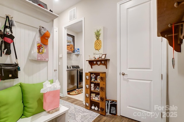 mudroom with hardwood / wood-style flooring and washer and clothes dryer