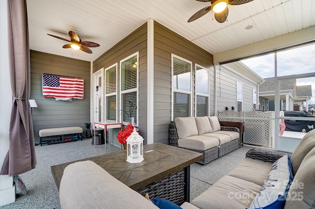 sunroom featuring ceiling fan and wooden ceiling