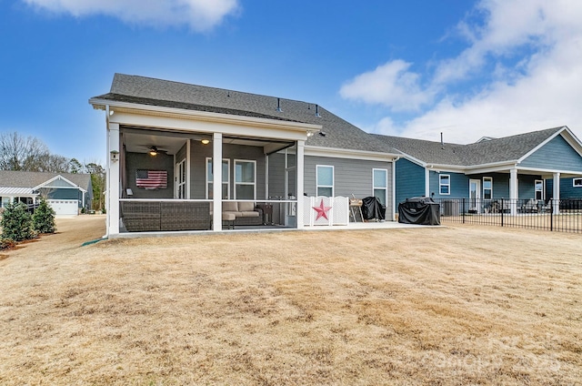 back of property featuring a patio, a yard, and a sunroom