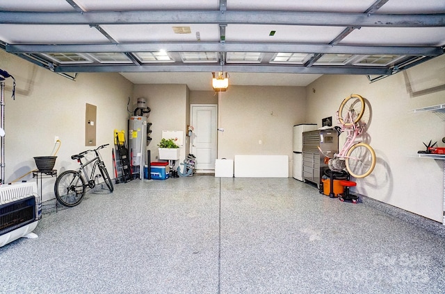 garage with a garage door opener and water heater