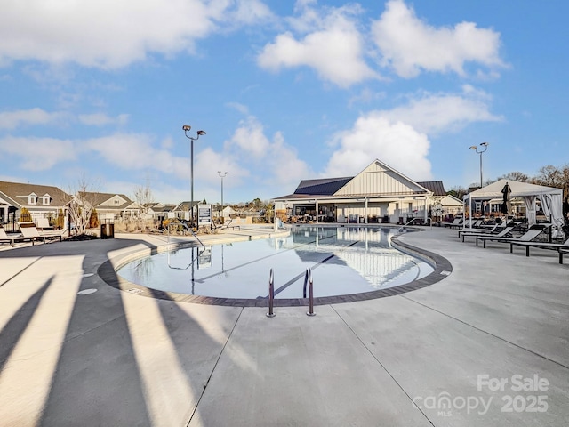 view of swimming pool with a patio and a gazebo