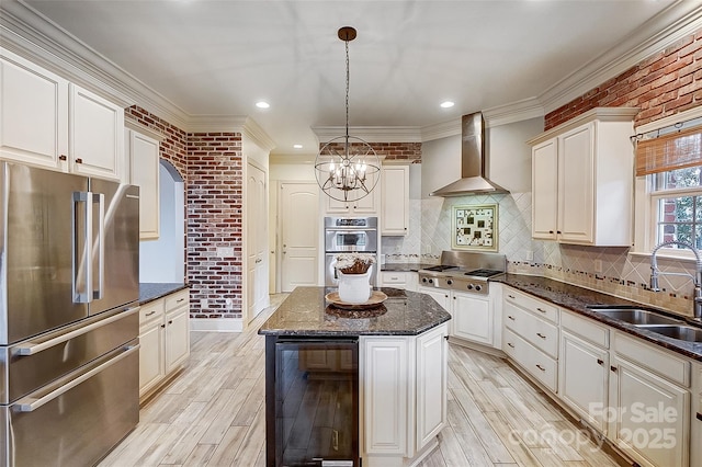 kitchen with a kitchen island, sink, wine cooler, stainless steel appliances, and wall chimney range hood