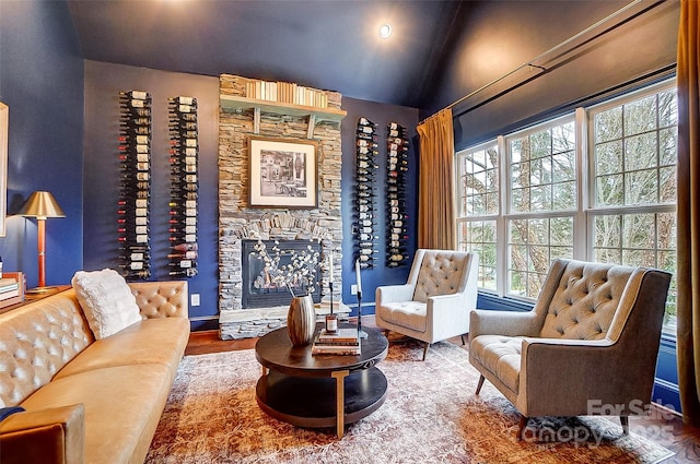 living area featuring vaulted ceiling and hardwood / wood-style floors