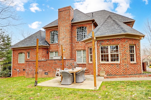 rear view of property with a yard and a patio area