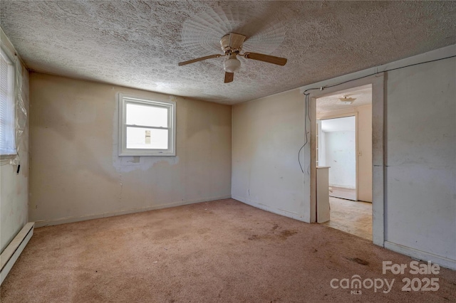 carpeted spare room with a baseboard heating unit, a textured ceiling, and ceiling fan