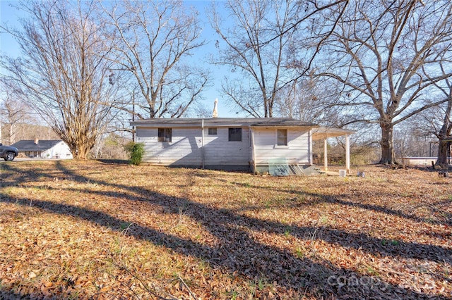 back of property with a lawn