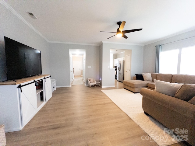 living room with ceiling fan, crown molding, and light wood-type flooring